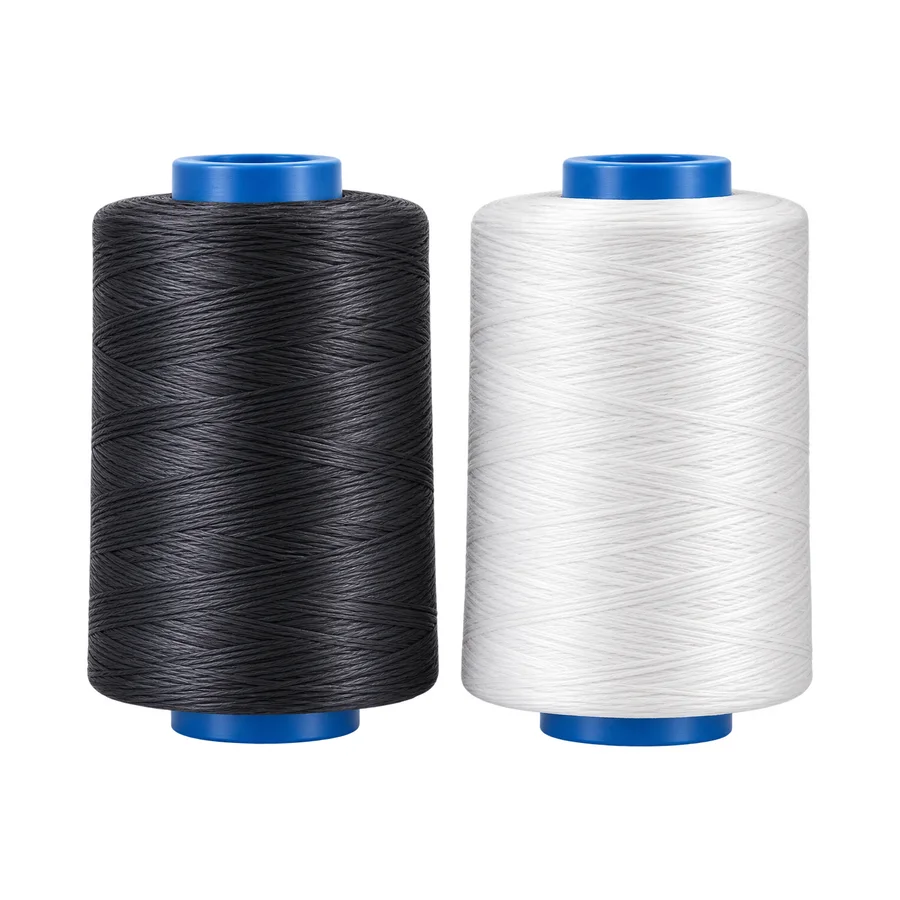 Two yarn cones side by side — black conductive antistatic yarn and white base polymer yarn